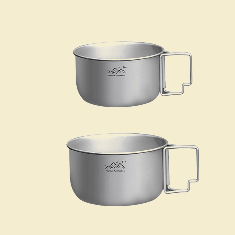 Titanium alloy camping pot on tan background